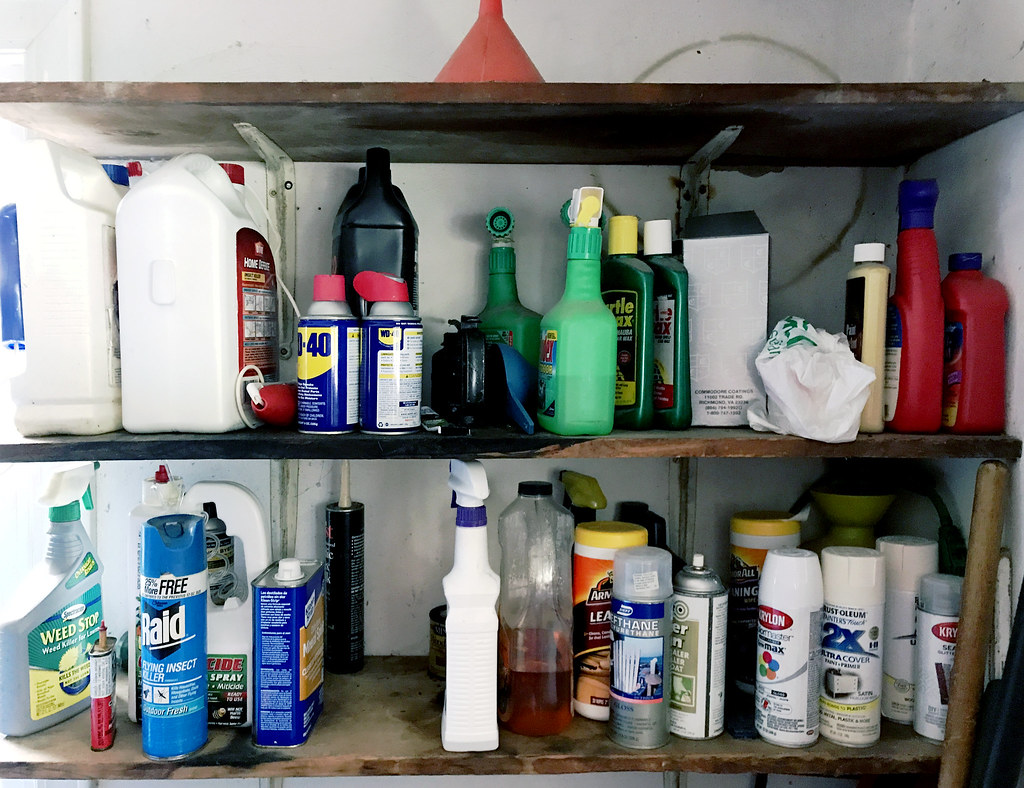 Two shelves full of household hazardous waste. Such as cleaners, insect and bug sprays, etc.