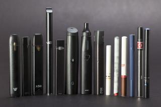 14 different types of e-cigarettes and vapes in a line. 