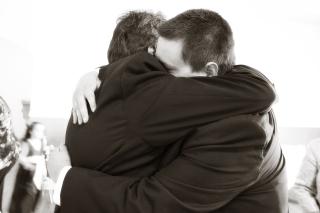 Two men in an emotional embrace. 
